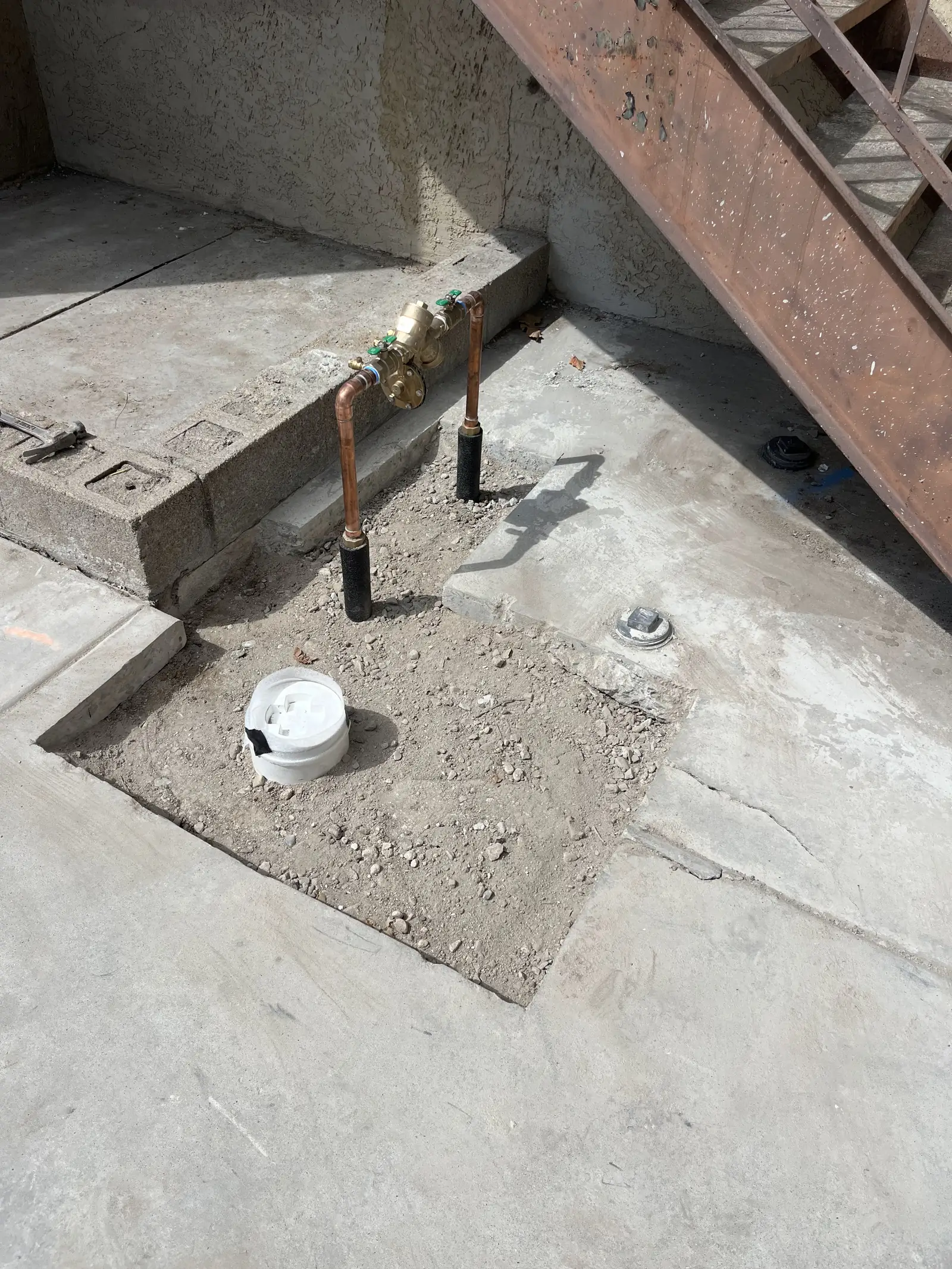 Backflow preventer set in concrete